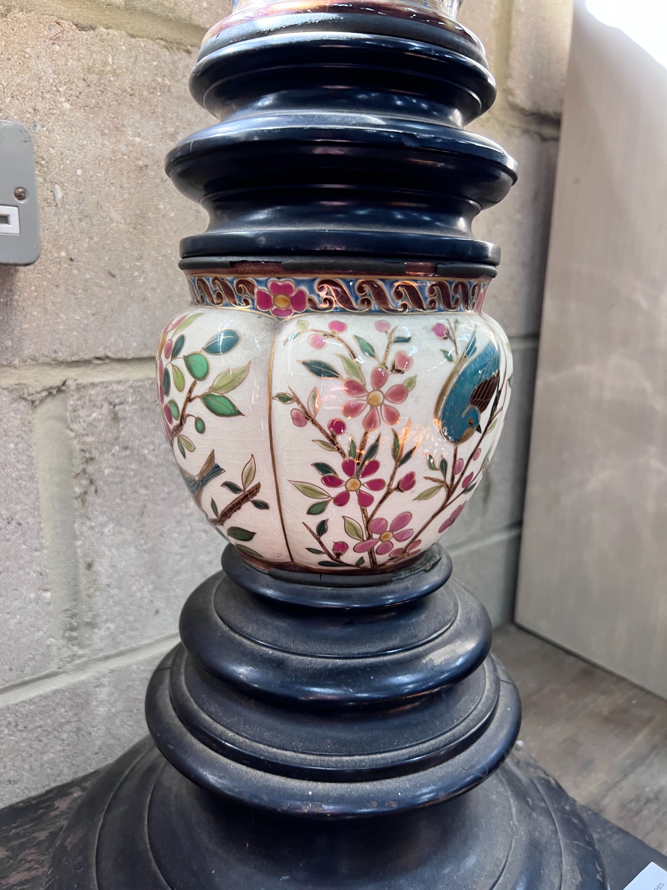 A 19th century ebonised porcelain mounted pedestal, height 105cm *Please note the sale commences at 9am.